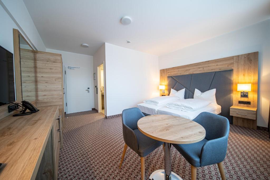 Postel nebo postele na pokoji v ubytování EE Hotel