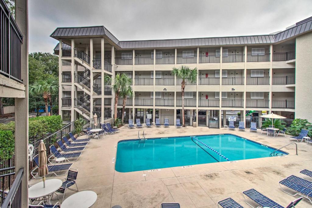an exterior view of a hotel with a swimming pool at Couples Retreat Walk to Coligny Plaza and Beach! in Hilton Head Island