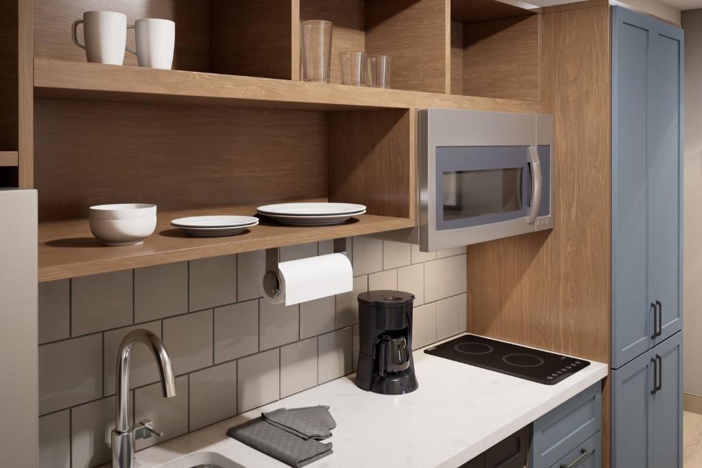 a kitchen with a microwave and a counter top at Candlewood Suites - Kingston West, an IHG Hotel in Kingston