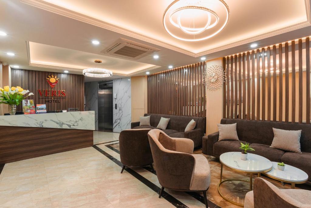 a lobby of a hotel with couches and tables at Hanoi Veris Boutique Hotel & Spa in Hanoi