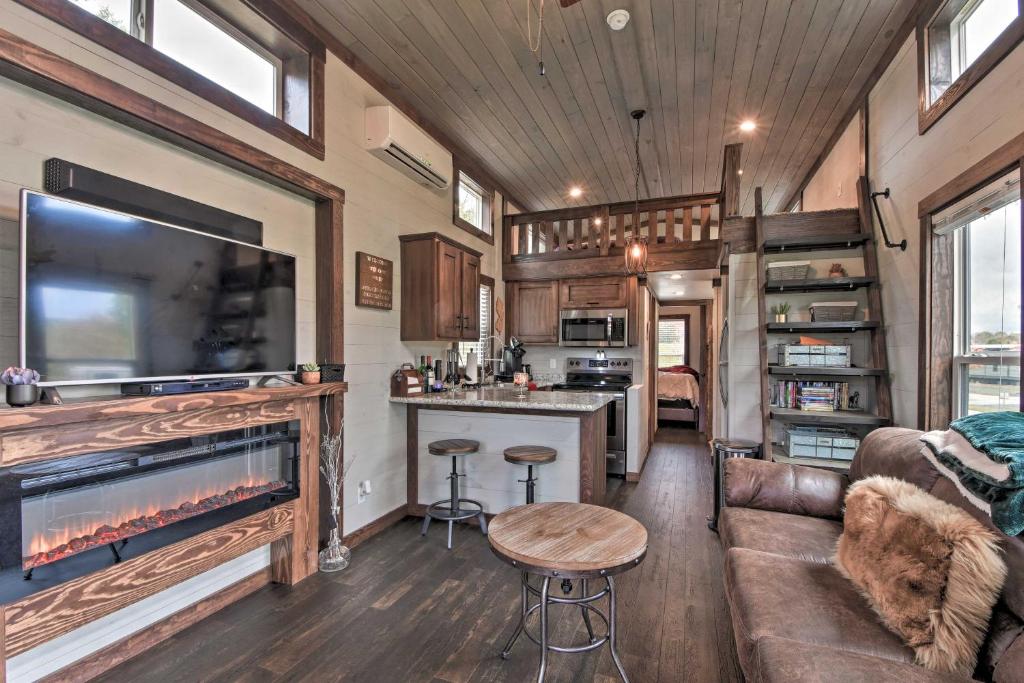 a living room and kitchen in a tiny house at Secluded Morganton Tiny Home with Hot Tub Access! in Morganton