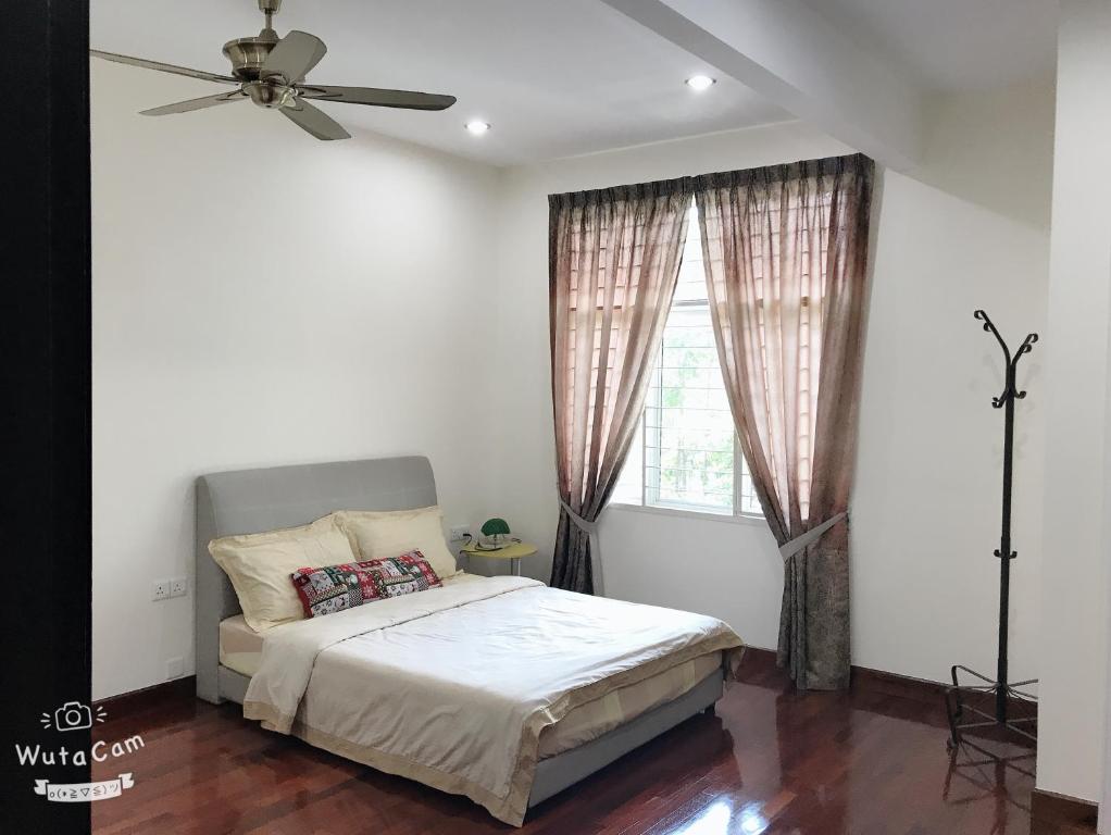 een slaapkamer met een bed en een plafondventilator bij Home sweet home in Subang Jaya