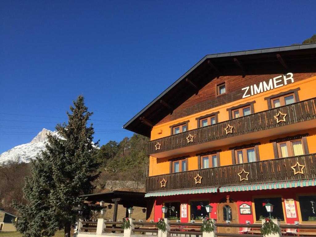 a zermatt hotel with a tree in front of it at Bed & Breakfast Plattenhof in Telfs