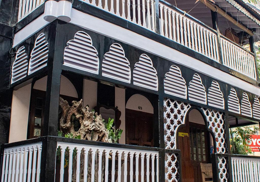 a black and white building with a balcony at The Ferreiras in Mumbai