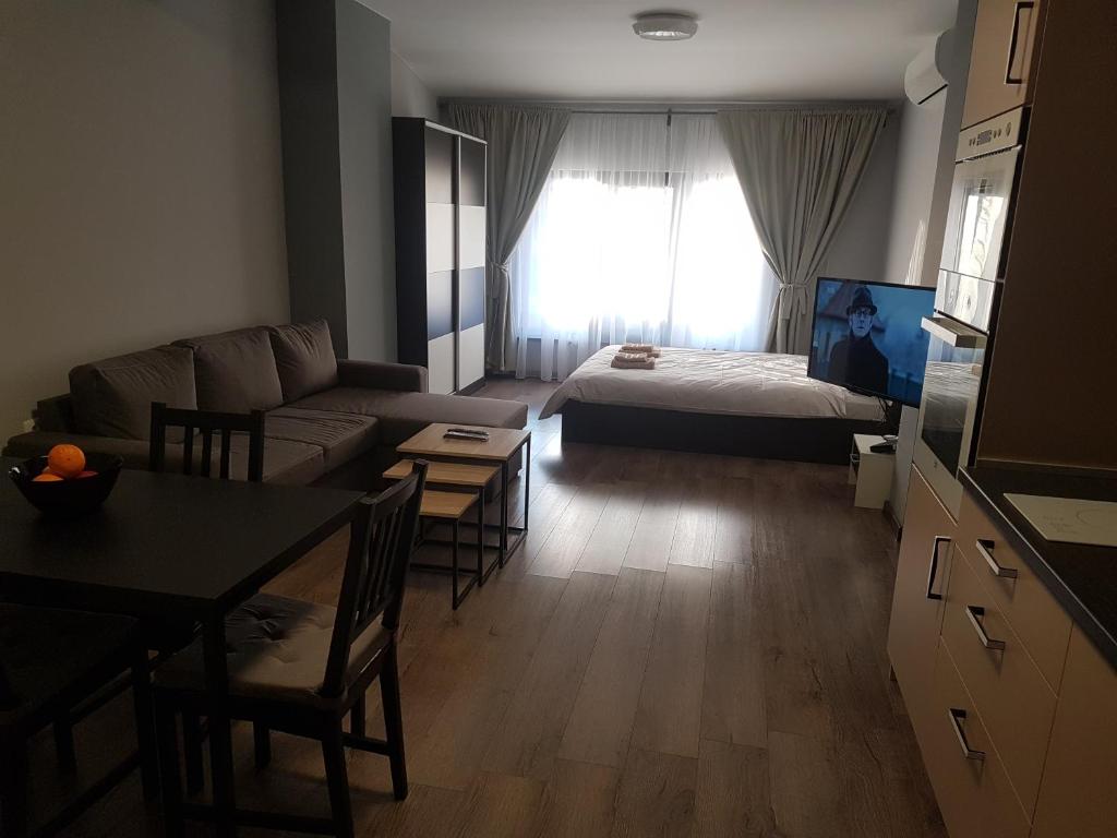a living room with a couch and a table and a bed at LUXURY SUITES 3 in Karlovo