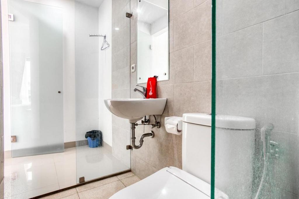 a bathroom with a toilet and a sink at Puri Maju Hotel in Jakarta