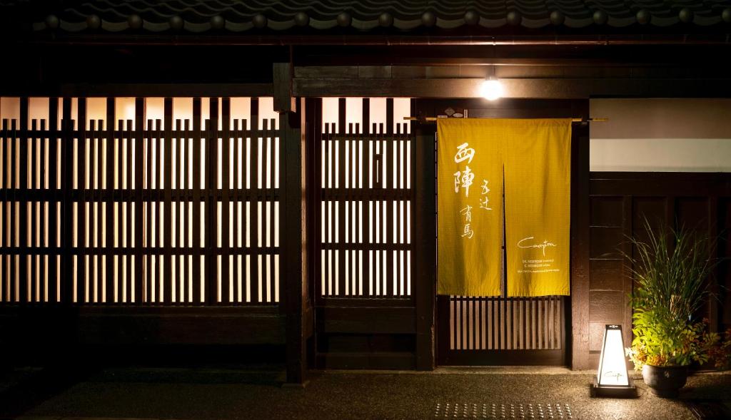 a gate with a yellow curtain in front of a building at Campton Nishijin Vacation Rental in Kyoto