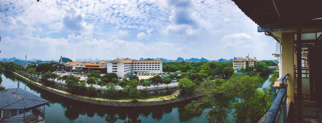 a view of a city with a river and buildings at Zen Tea House Seven Stars Park in Guilin