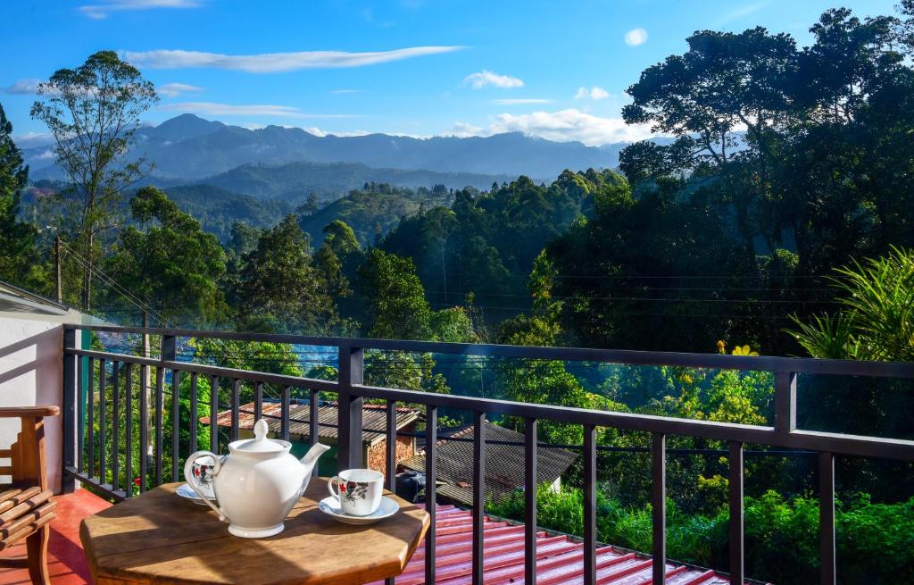balcón con mesa y vistas a las montañas en Ella Nature Life Guest Inn by Silaa Cabana, en Ella