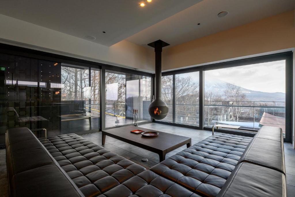 a large living room with a couch and a large window at Sekka Sekka in Niseko