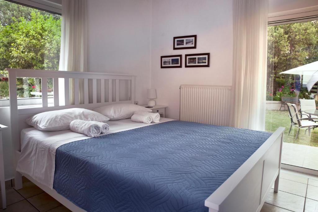 a bedroom with a bed and a large window at Villa SteMa in Xirokámbion