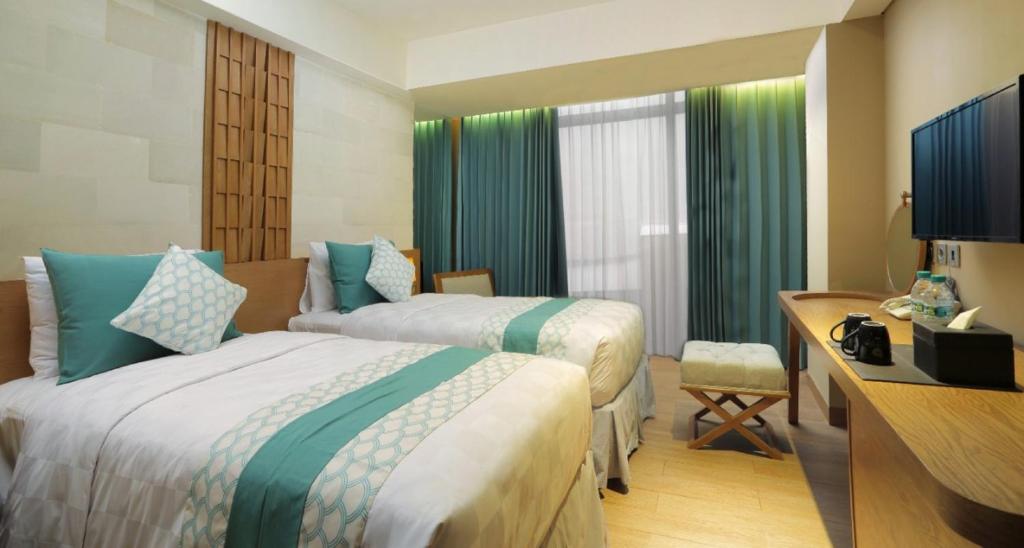 Postel nebo postele na pokoji v ubytování Bedrock Hotel Kuta