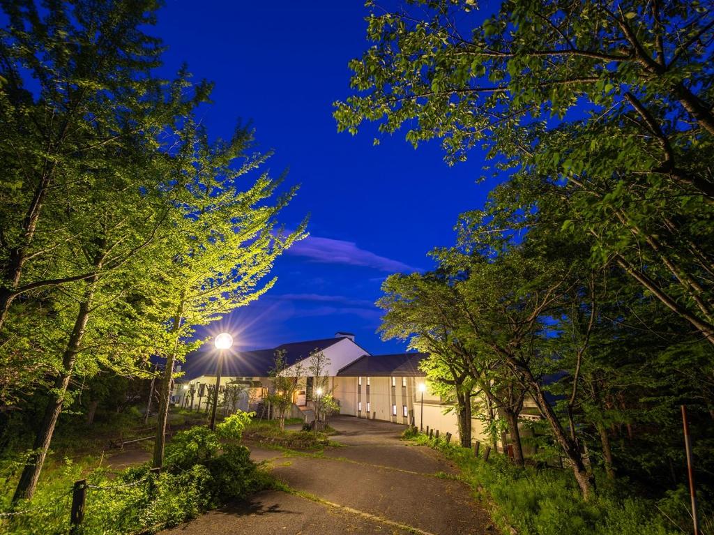 a house on a street at night with trees at Lake View Inawashiro in Inawashiro