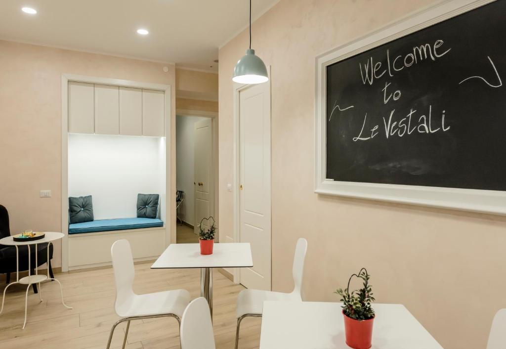 a classroom with tables and chairs and a chalkboard on the wall at Le vestali Guest House in Rome