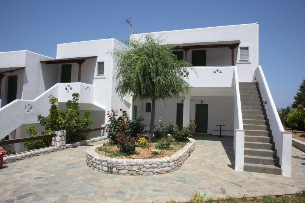 une maison blanche avec un escalier en face de celle-ci dans l'établissement Studios Marianna, à Skiros