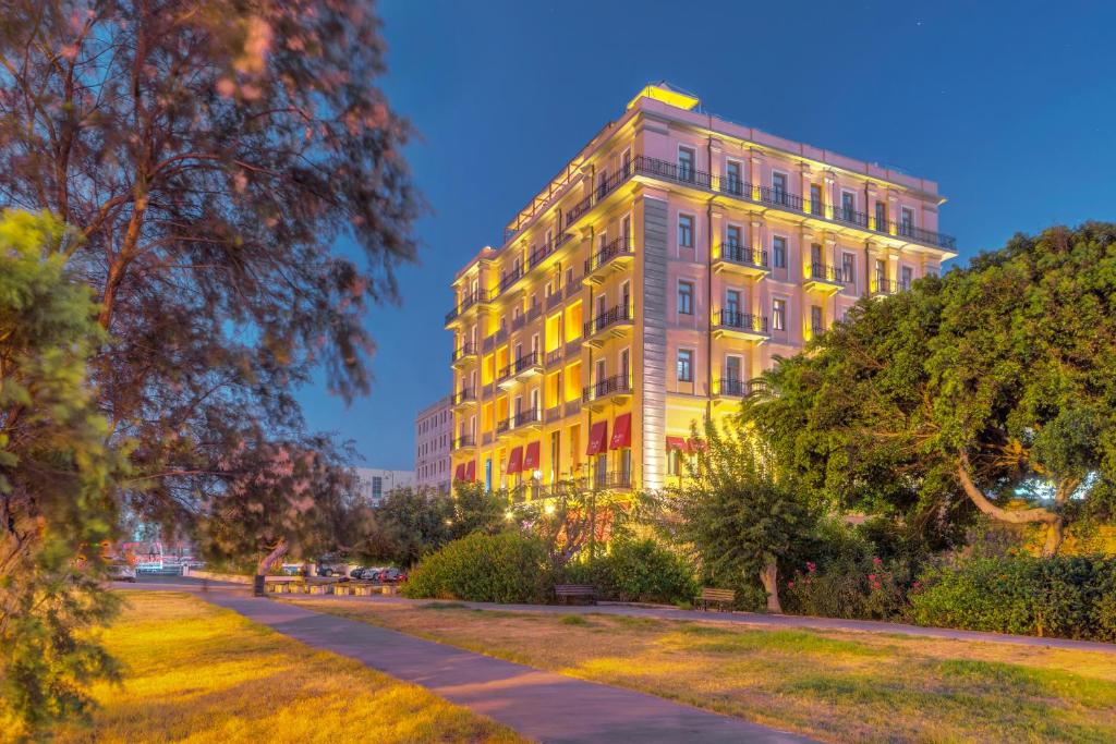 a building in a park at night at GDM Megaron, Historical Monument Hotel in Heraklio