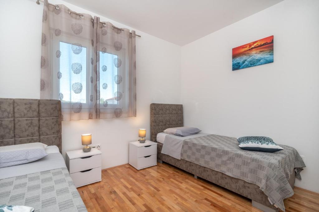 Posteľ alebo postele v izbe v ubytovaní Apartman Paty&Inky