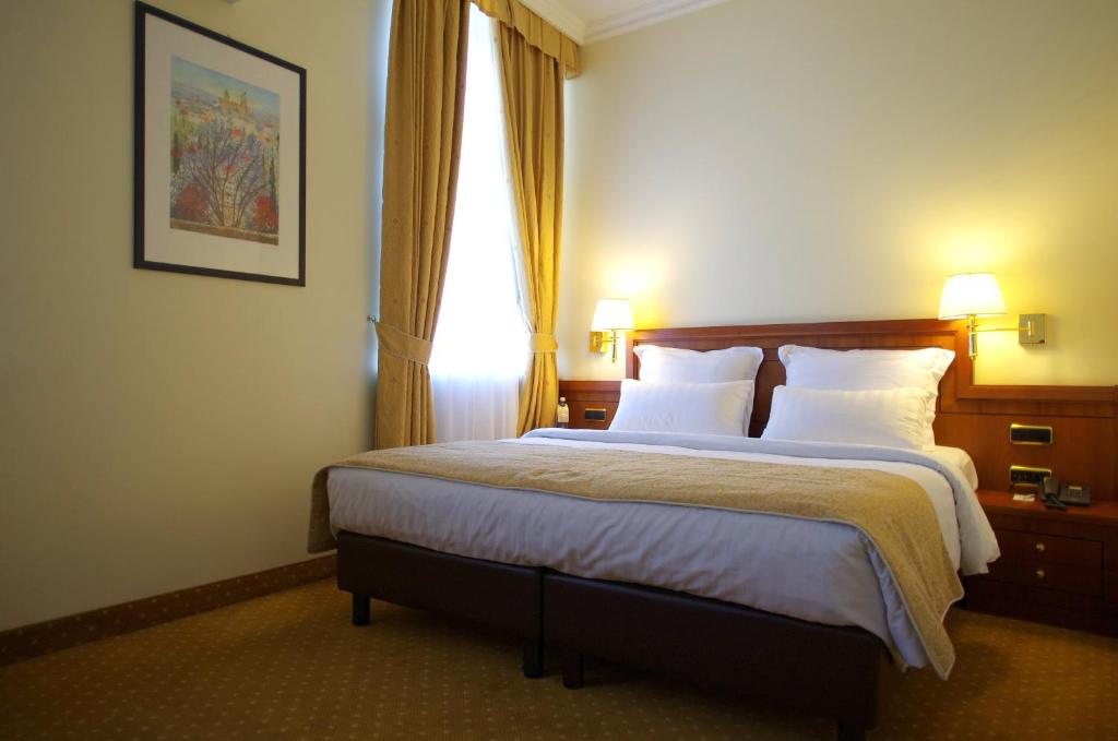 Postel nebo postele na pokoji v ubytování My City Hotel