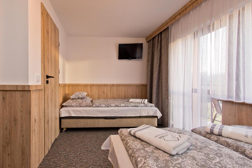 Posteľ alebo postele v izbe v ubytovaní Pokoje Gościnne Kornelia- Jacuzzi & Sauna