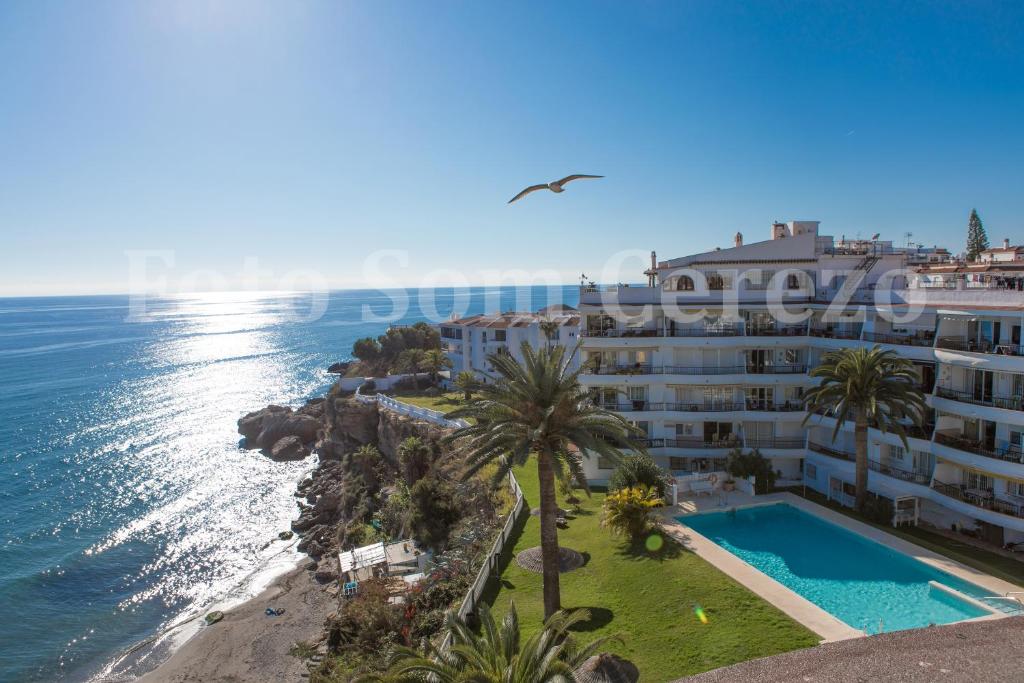 an aerial view of a building next to the ocean at Acapulco playa Nerja 407 planta superior in Nerja