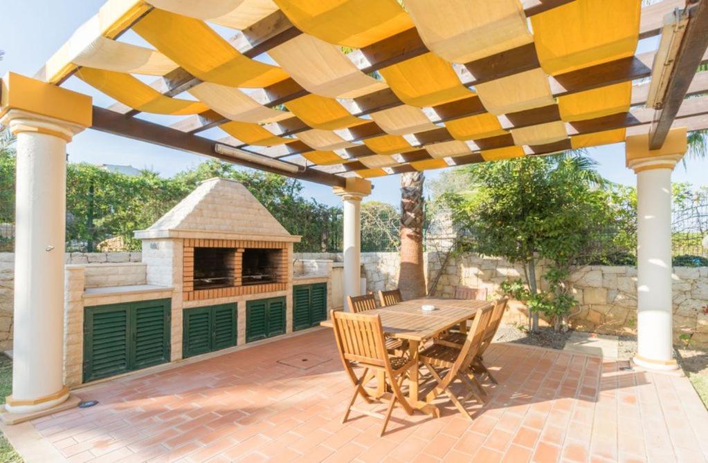 d'une terrasse avec une table en bois et un kiosque. dans l'établissement Casa Campo in Guia with 4 bedrooms sleeps 8 AcWiFi and private pool, à Guia