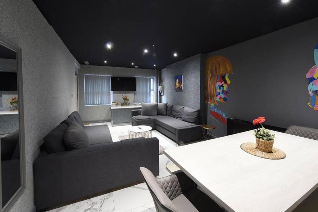 a living room with a couch and a table at Back Turner Townhouse in Manchester