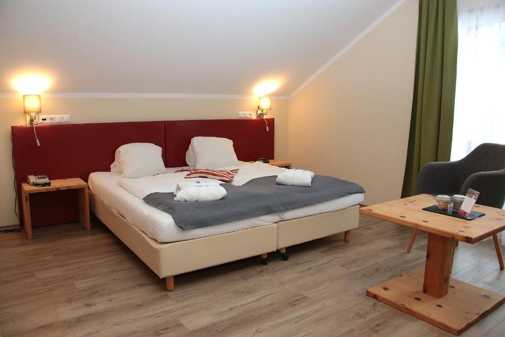 A bed or beds in a room at Genusshotel Almrausch