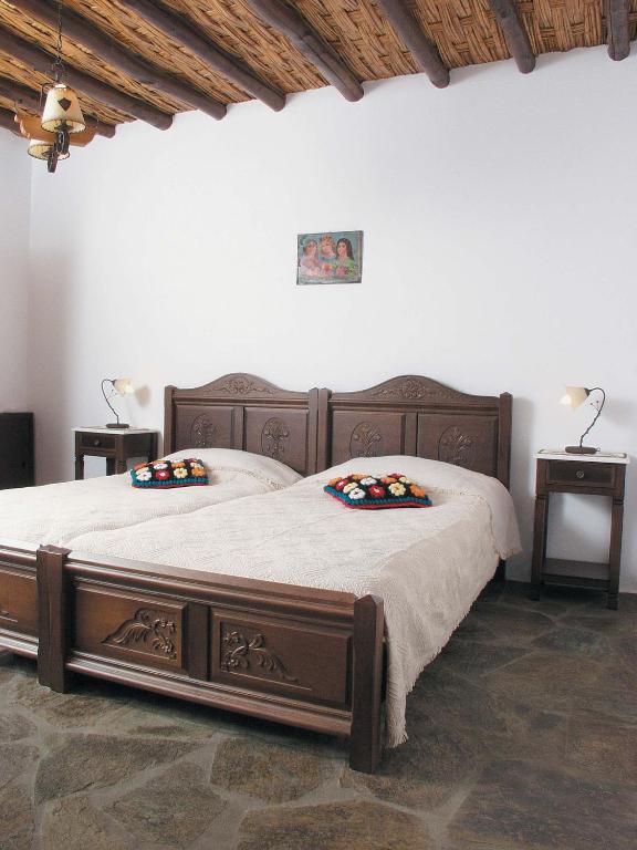 a bedroom with a large bed with two pillows on it at Anastasia Luxury Villas in Gavrio