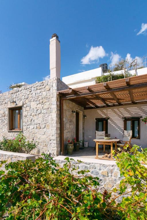 a patio of a house with a wooden table at Villa Maria in Stavrokhórion