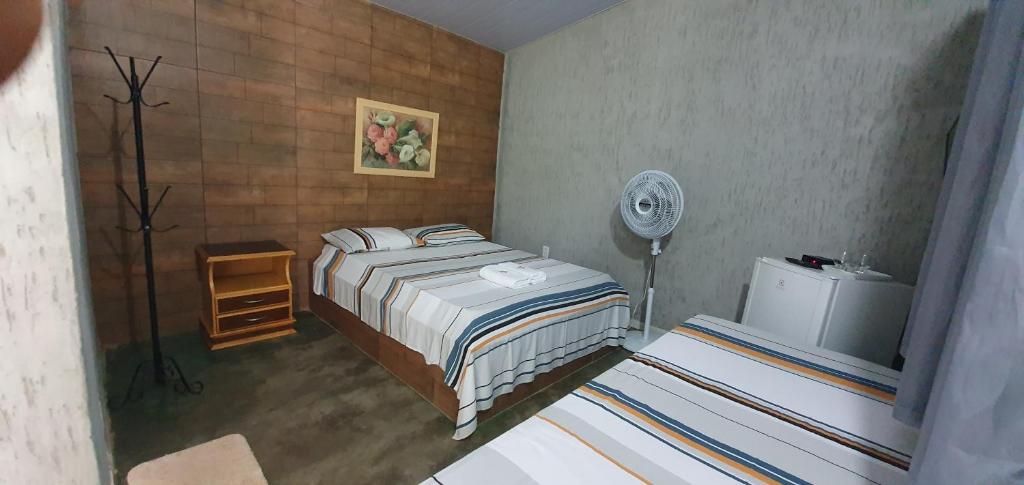 a rendering of a bedroom with a bed and a fan at Pousada Recanto da Mata in Cavalcante