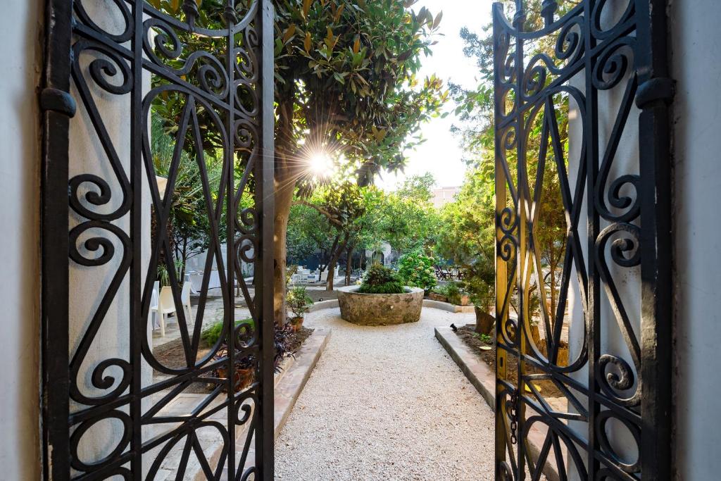 une porte menant à un jardin avec une passerelle dans l'établissement Il Giardino di Tonia - Oplontis Guest House - Bed & Garden -, à Torre Annunziata