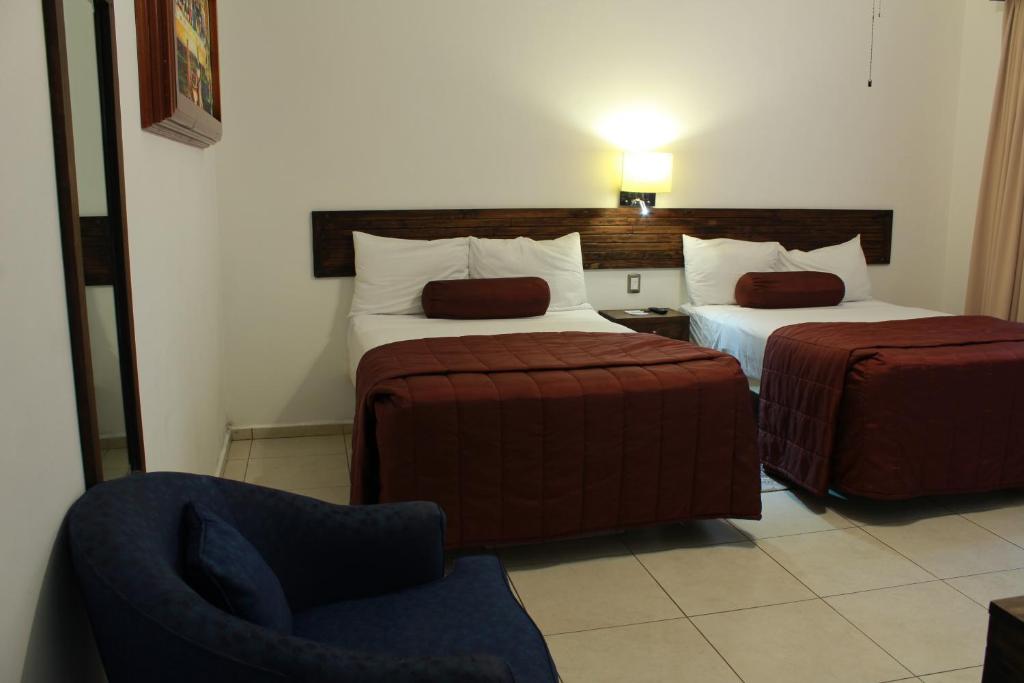 Postel nebo postele na pokoji v ubytování HOTEL MI SOLAR EJECUTIVO