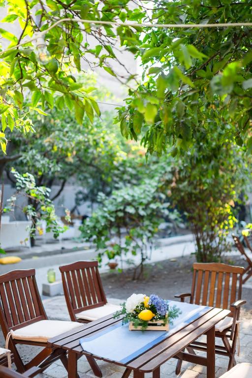 a picnic table with two chairs and a bowl of fruit on it at Il Giardino di Tonia - Oplontis Guest House - Bed & Garden - in Torre Annunziata