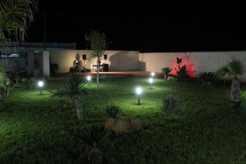 een tuin met lichten in het gras 's nachts bij B&B Italia in Carmiano