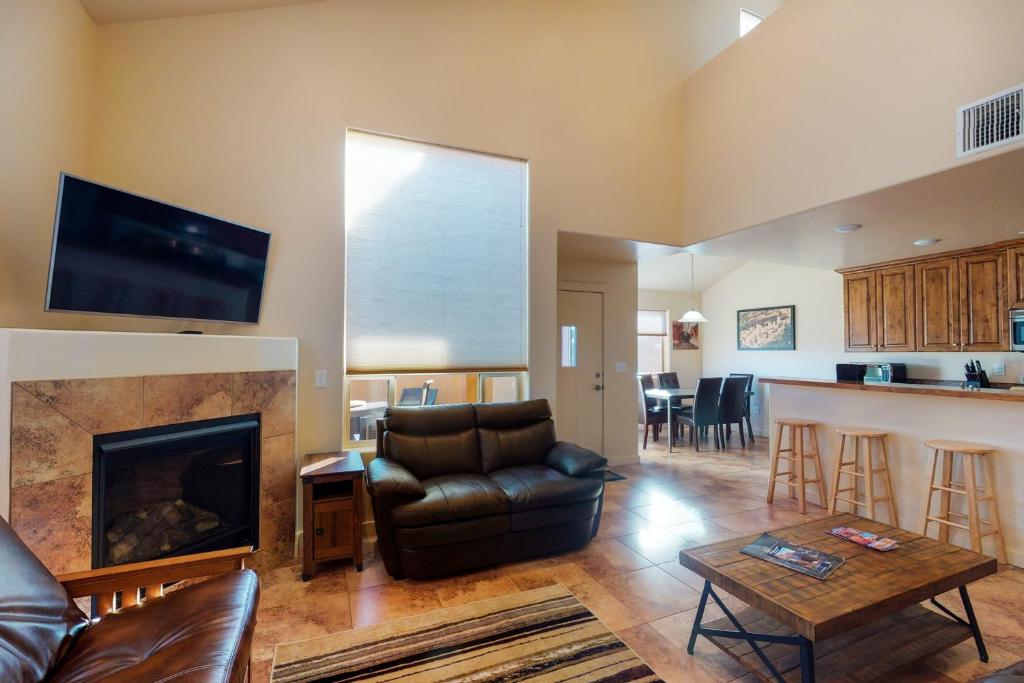 a living room with a couch and a fireplace at Rim Vista 11A2 in Moab