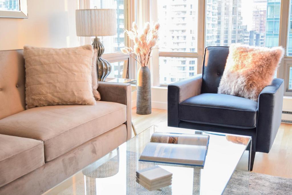 a living room with a couch and a chair and a table at Vancouver Extended Stay in Vancouver