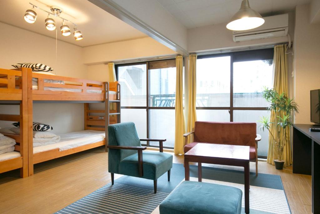 a bedroom with bunk beds and a desk and a chair at Nishi Nakasu apartment 301 in Fukuoka