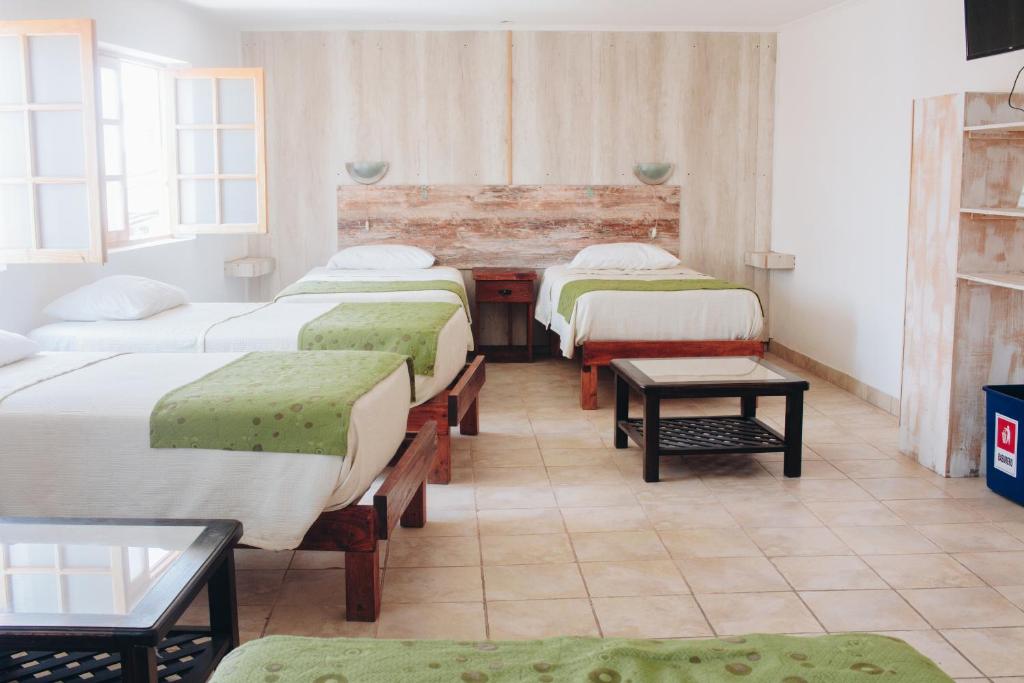 Postel nebo postele na pokoji v ubytování Hostal Valle Mistral
