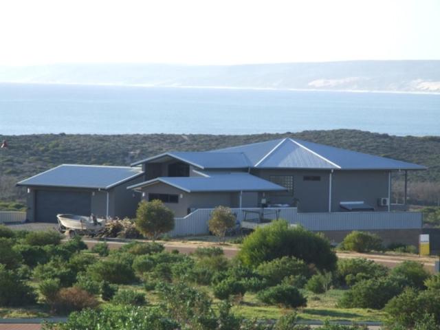 a large building with the ocean in the background at Eco Haven retreat in Kalbarri