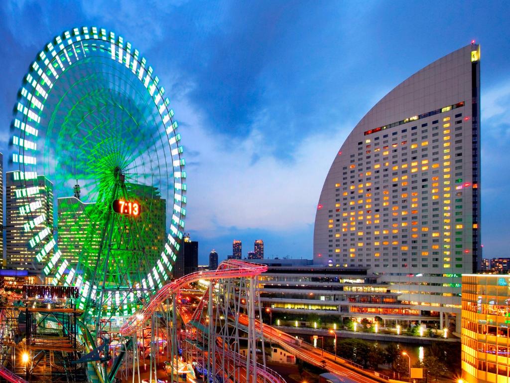 a large ferris wheel in a city at night at InterContinental Yokohama Grand, an IHG Hotel in Yokohama