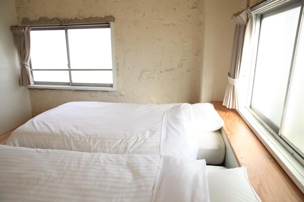 Postel nebo postele na pokoji v ubytování 14 Guesthouse Mt.Fuji