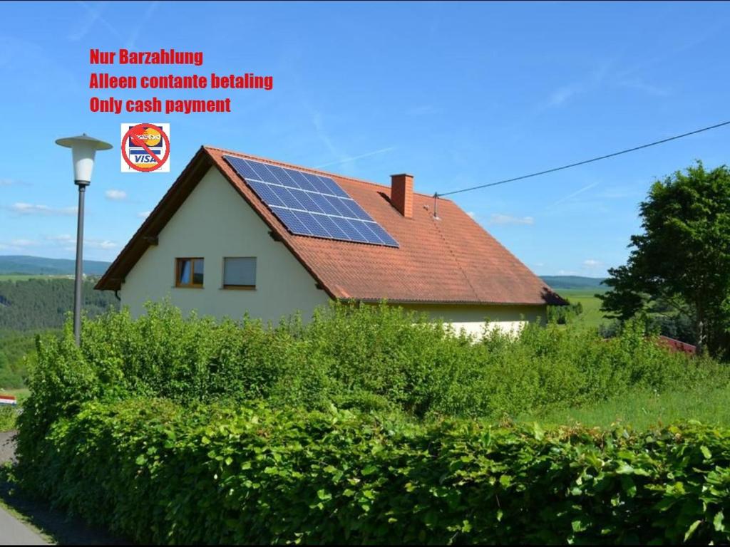 a house with solar panels on the roof at B&B Prosterath-Hochwald in Prosterath