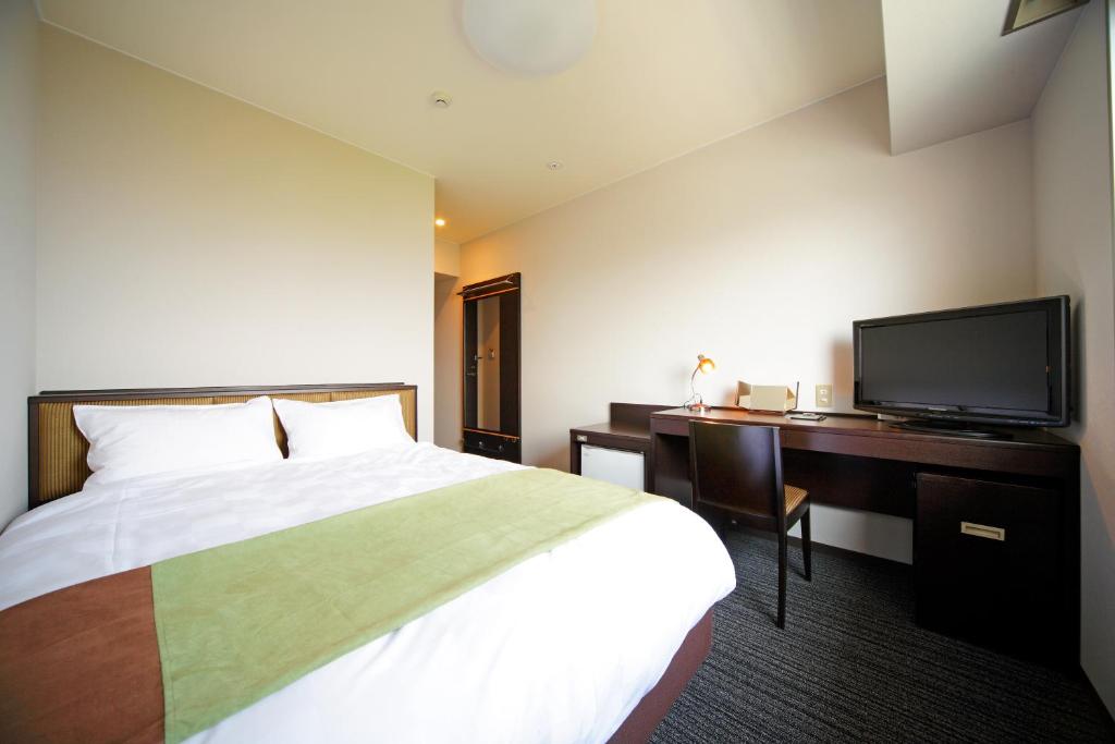 מיטה או מיטות בחדר ב-Green Hotel Yes Nagahama Minatokan