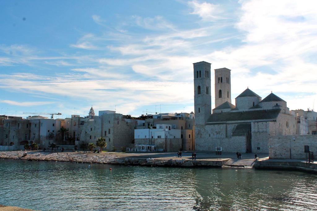 a group of buildings next to a body of water at Il Mulino di Amleto - Bed and Breakfast letterario in Molfetta