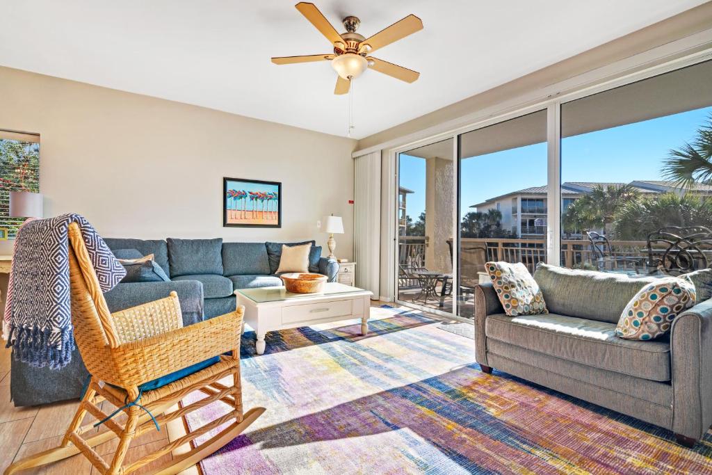 a living room with a couch and a chair at High Pointe 231 in Rosemary Beach