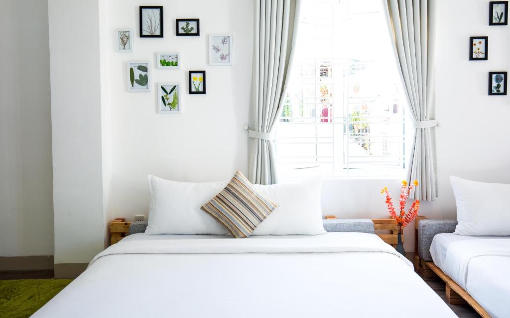 Postel nebo postele na pokoji v ubytování Nem's House Hội An