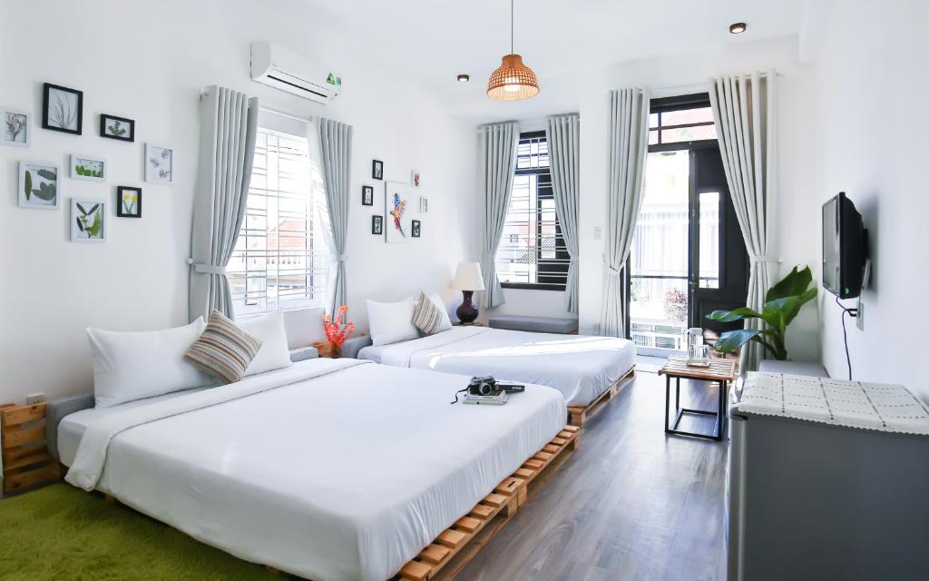 Postel nebo postele na pokoji v ubytování Nem's House Hội An
