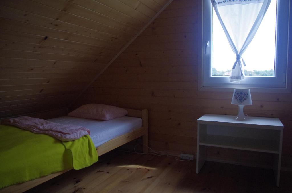 Postel nebo postele na pokoji v ubytování Cisowe Domki Nowęcin