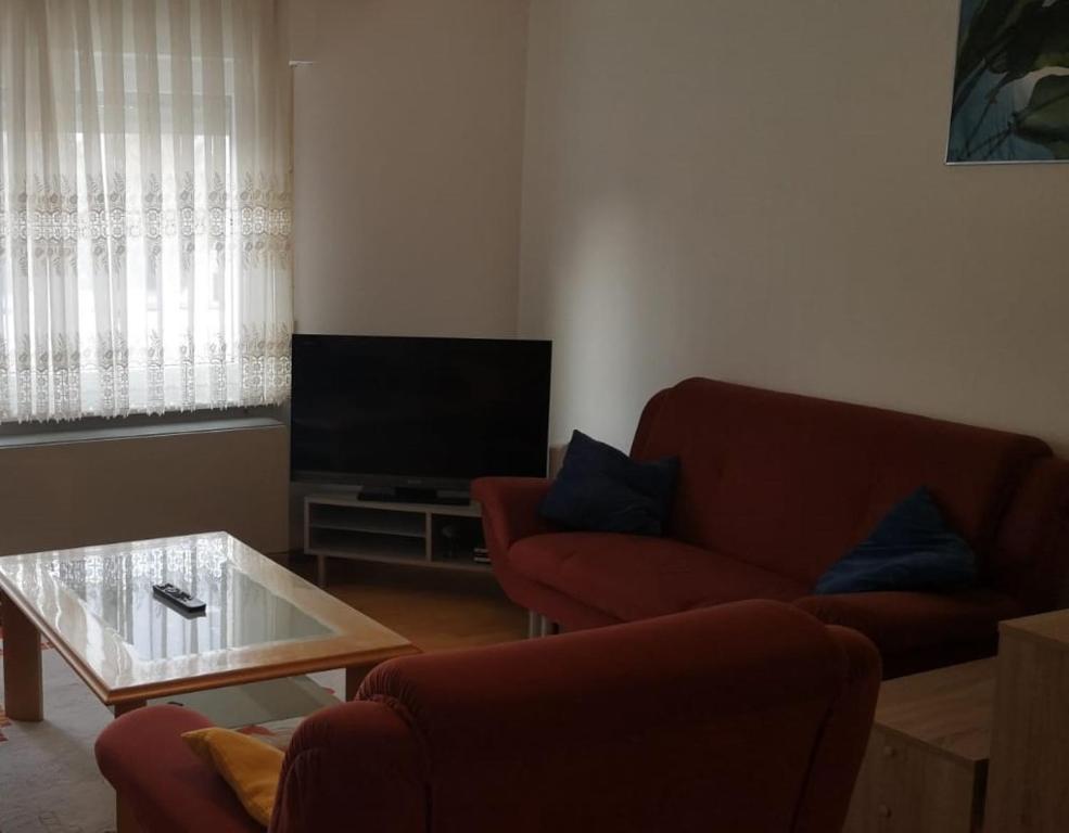 a living room with a couch and a television at Apartment Goldberg in Sindelfingen