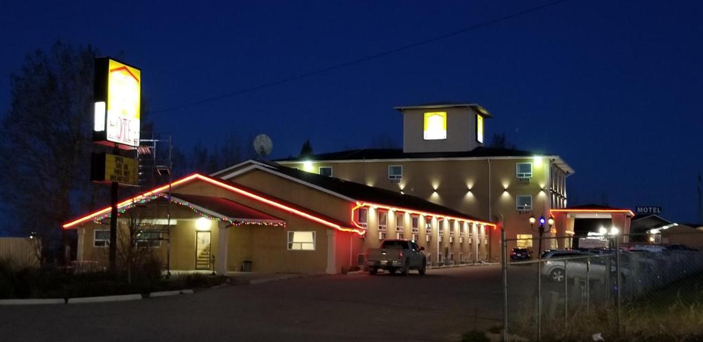 a building with a car parked in front of it at night at Lone Star Hotel in North Battleford